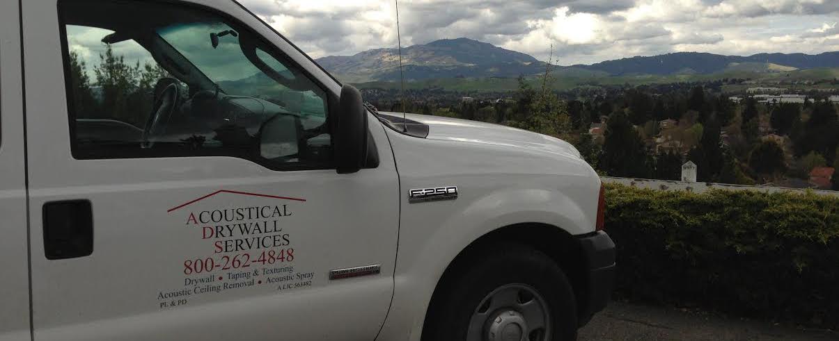 acoustical drywall services truck in front of auburn house in need of popcorn ceiling removal