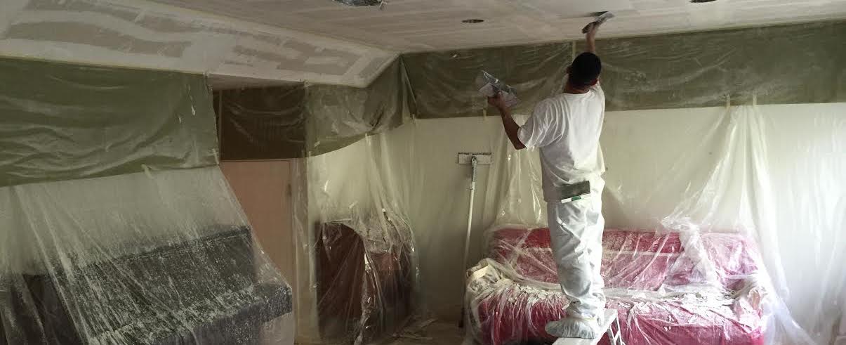 Acoustical Drywall Services worker doing popcorn ceiling removal on home in Livermore