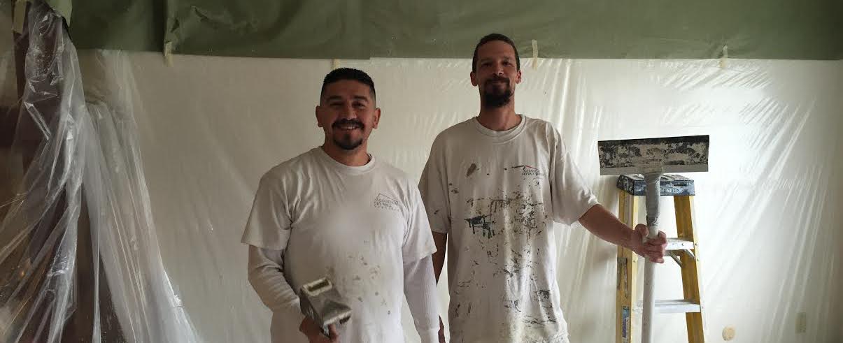 two acoustical drywall services employees working on popcorn ceiling removal project in Sacramento